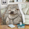 Pitbull blanket displayed on a sofa with rustic wood artwork, butterflies, and floral accents