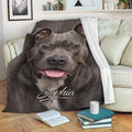 Pitbull blanket draped over a sofa with a close-up gray dog portrait and cozy reading setup