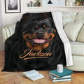 Rottweiler throw blanket draped over a sofa with books and a mug in a cozy living room