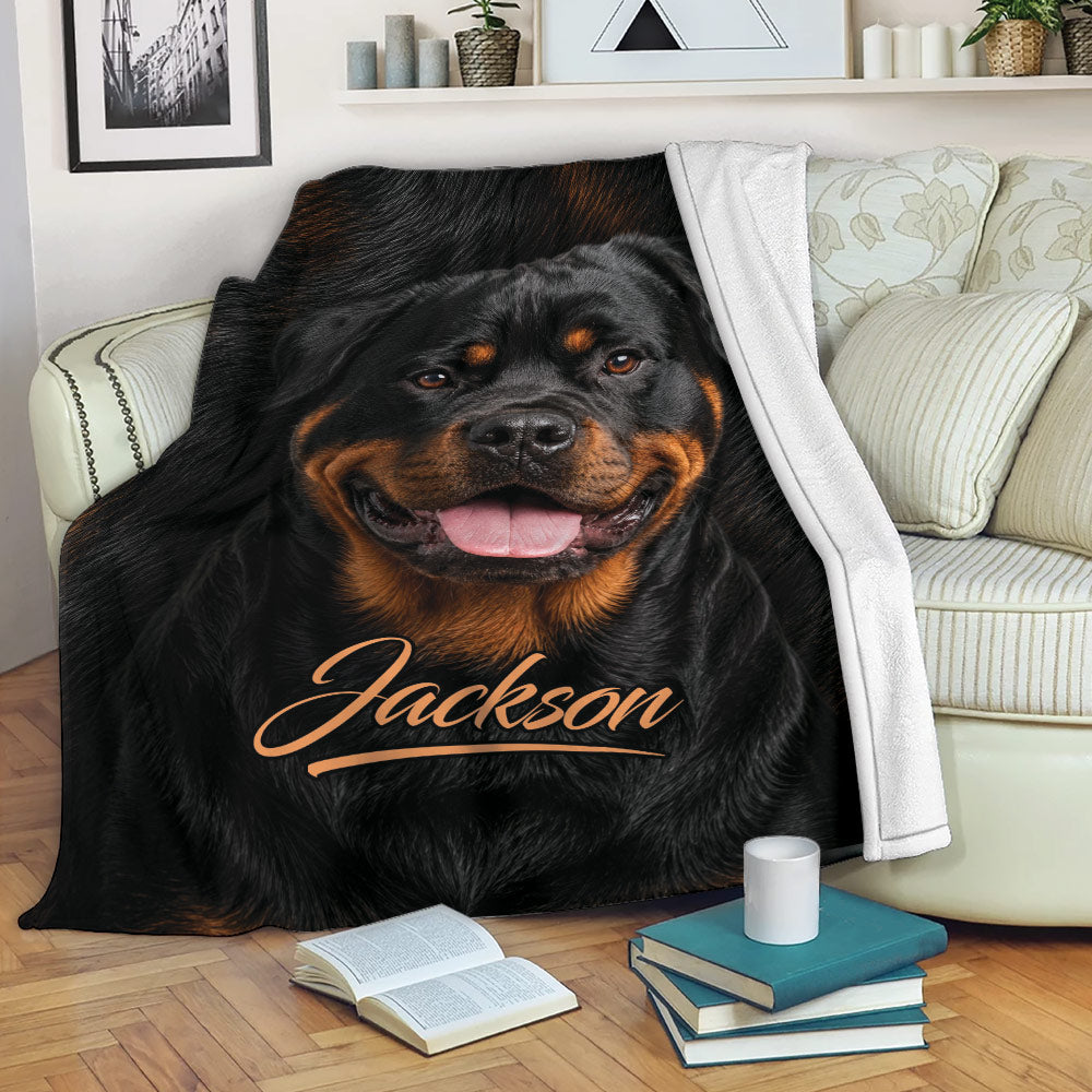 Rottweiler throw blanket draped over a sofa with books and a mug in a cozy living room