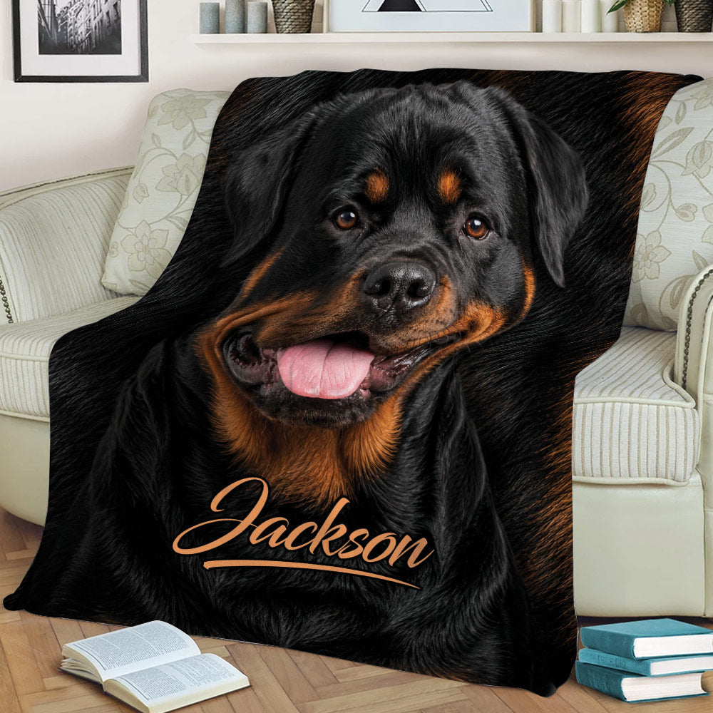 Close view of a black and tan Rottweiler throw blanket styled across a living room sofa