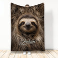 Sloth throw blanket displayed with a close-up smiling sloth design in warm brown tones