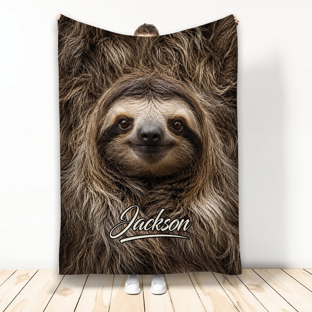 Sloth throw blanket displayed with a close-up smiling sloth design in warm brown tones