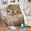 Guinea pig throw blanket displayed on a sofa with whimsical bath artwork and floral details