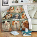 Guinea pig blanket displayed on a sofa with colorful floral cavy artwork
