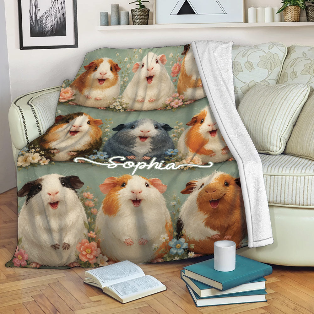 Guinea pig blanket displayed on a sofa with colorful floral cavy artwork