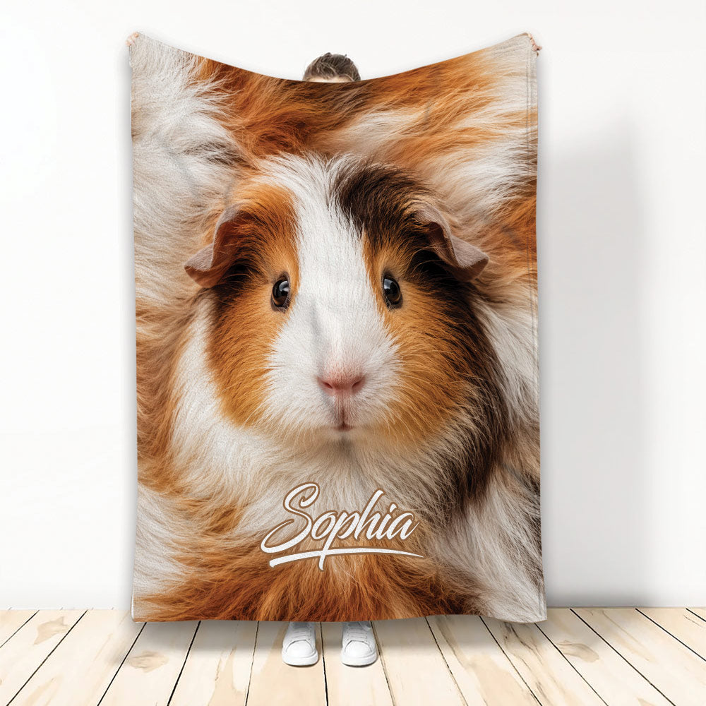 Brown, white, and black guinea pig design displayed on a blanket in a bright room