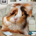 Close-up guinea pig throw blanket styled across a sofa with books nearby