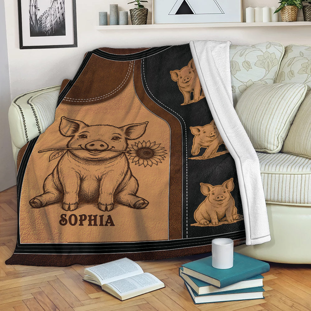 Pig throw blanket displayed on a sofa with playful pig artwork and warm brown and black tones