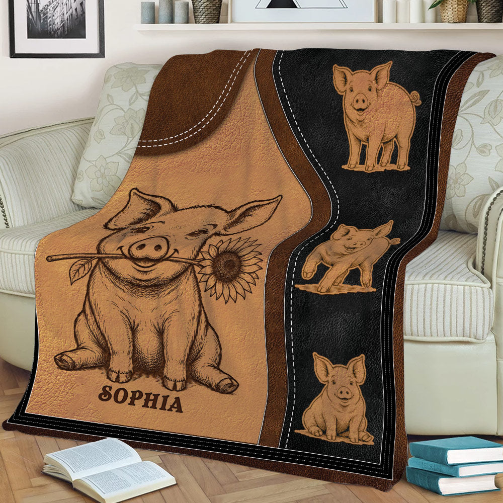 Close lifestyle view of a pig blanket draped over a sofa with sunflower and pig illustrations