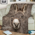 Close-up realistic donkey blanket styled across a sofa with warm rustic living room decor