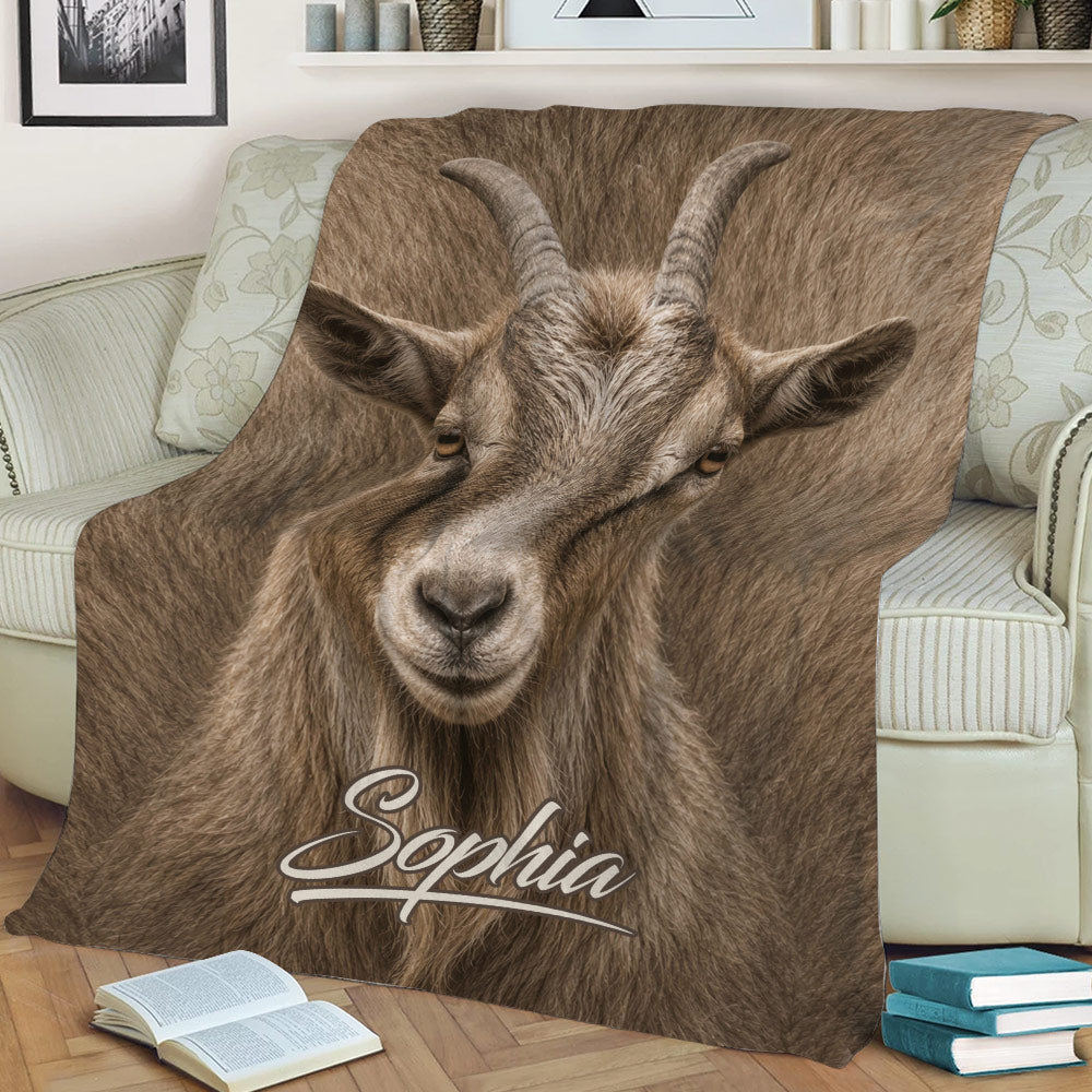 Close lifestyle view of a realistic goat throw blanket styled on a sofa with books nearby