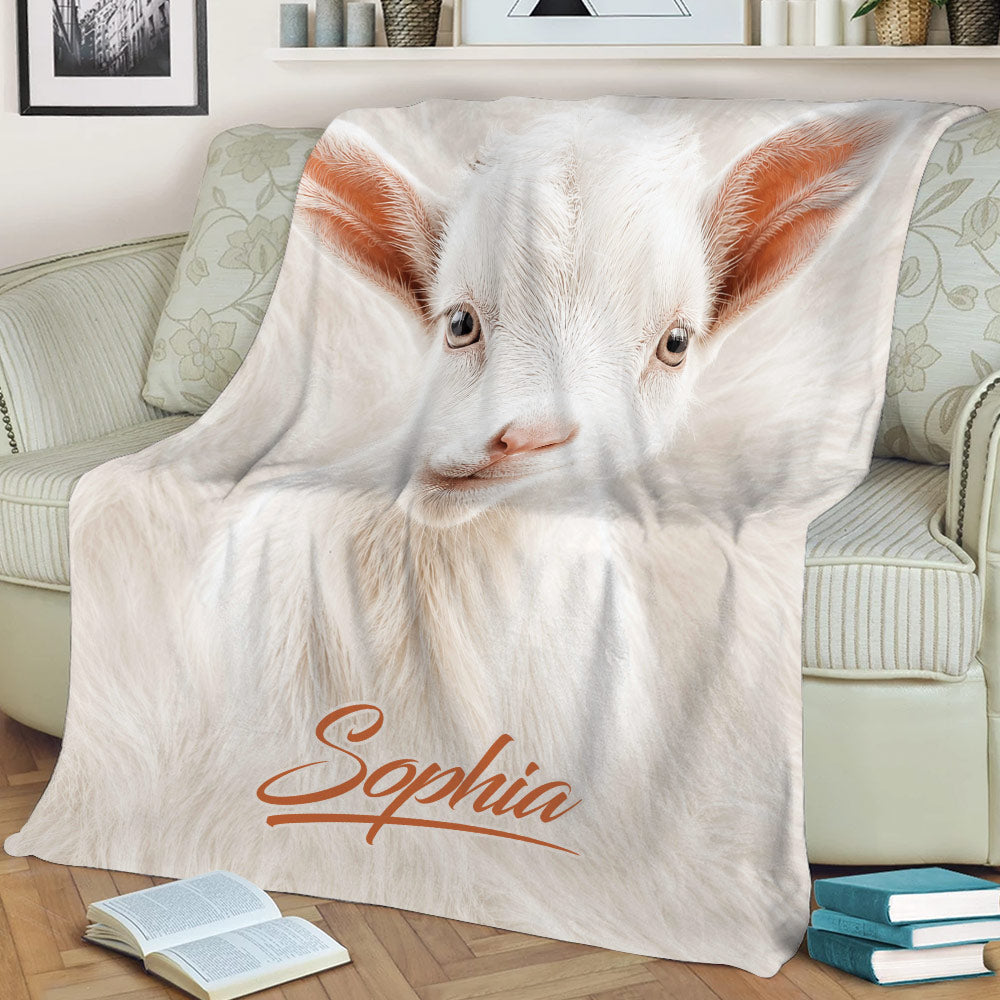 Close-up white goat throw blanket styled across a sofa with books nearby