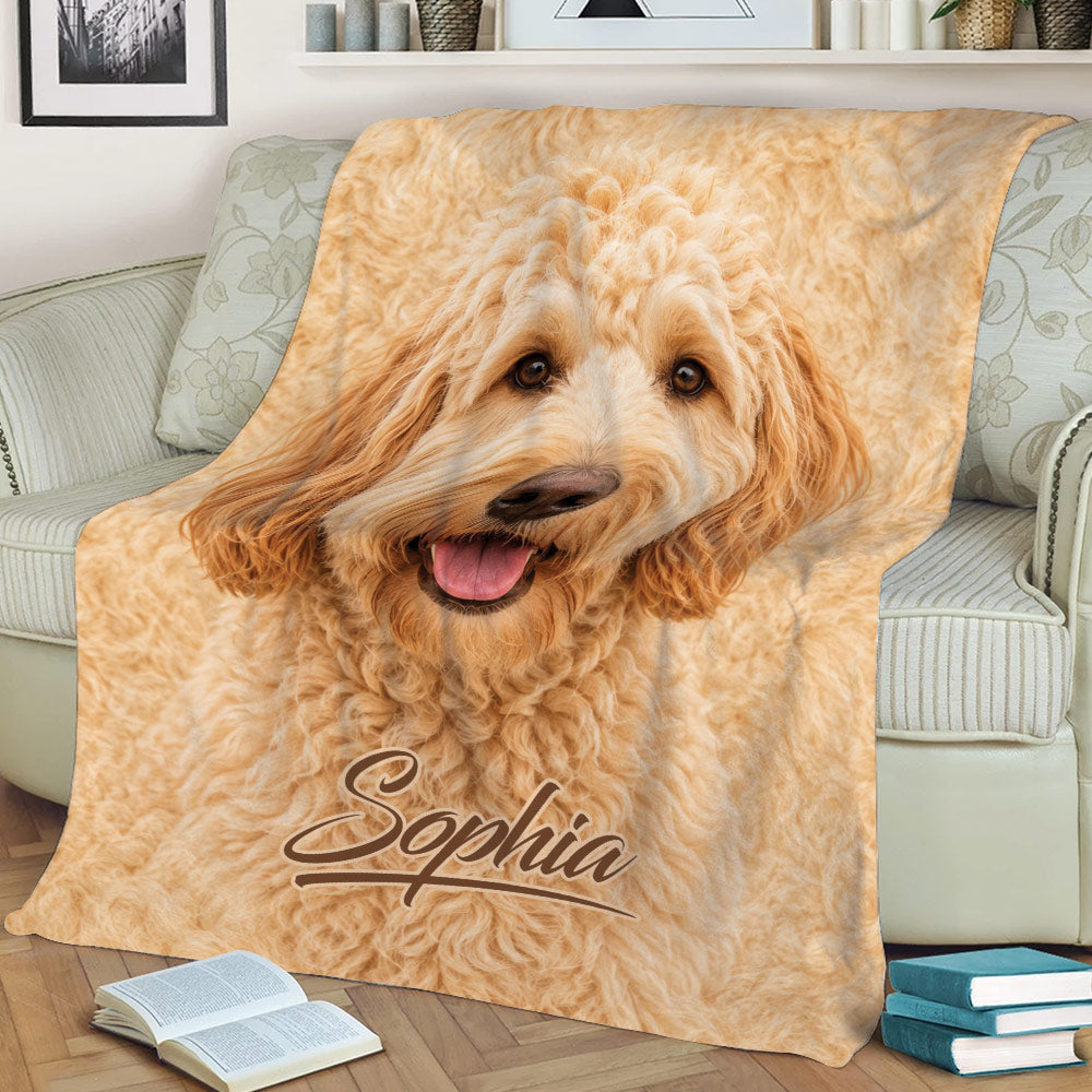 Golden Labradoodle throw blanket displayed across a sofa with a close-up curly dog design