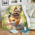 Yorkshire Terrier throw blanket displayed on a sofa with colorful outdoor watercolor artwork