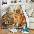 Golden Retriever throw blanket displayed on a sofa with floral garden artwork and cozy reading decor