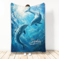 Dolphin blanket featuring two dolphins swimming through bright blue underwater ocean artwork