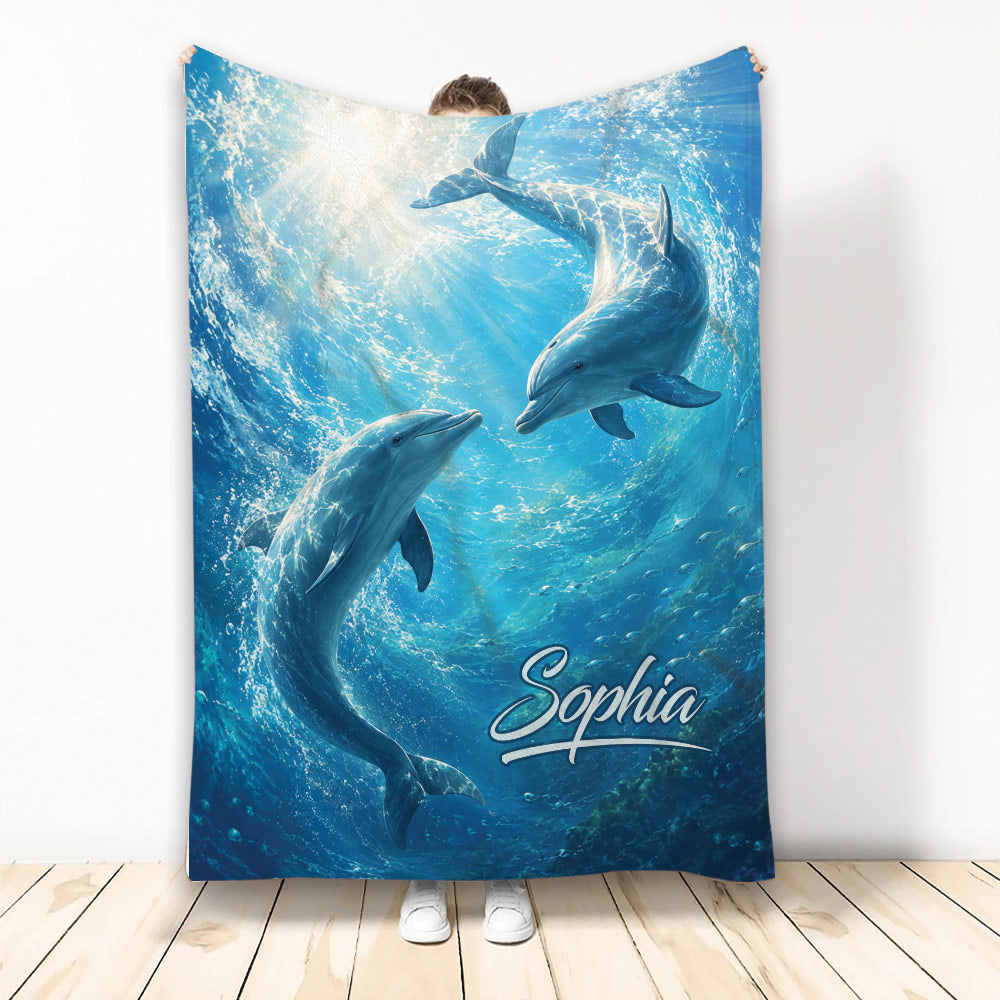 Dolphin blanket featuring two dolphins swimming through bright blue underwater ocean artwork