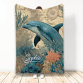 Dolphin throw blanket displayed against a wall with vintage map and colorful underwater coral artwork