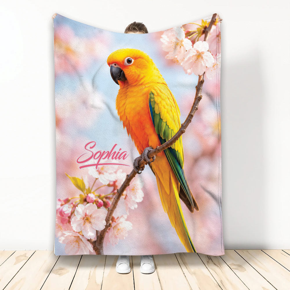 Colorful conure bird blanket with tropical plumage and pink cherry blossoms displayed vertically