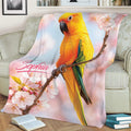 Bright conure throw blanket featuring a perched bird, flowering branch, and soft pastel background