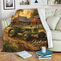 Tractor throw blanket draped over a sofa with vintage farm artwork, rustic barn scenery, and warm autumn colors