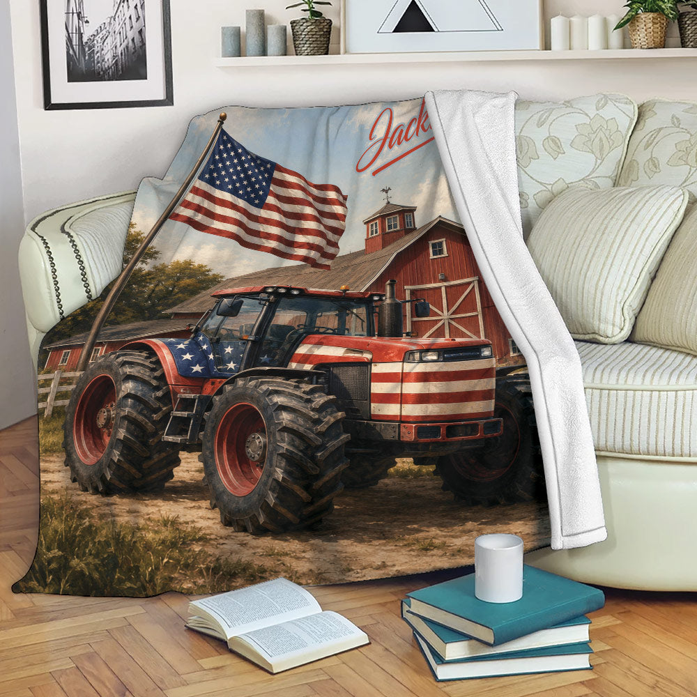 Patriotic tractor throw blanket draped over a sofa with American flag, barn, and countryside artwork