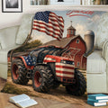 Close view of a patriotic tractor blanket with red barn, silo, American flag, and rustic farm artwork