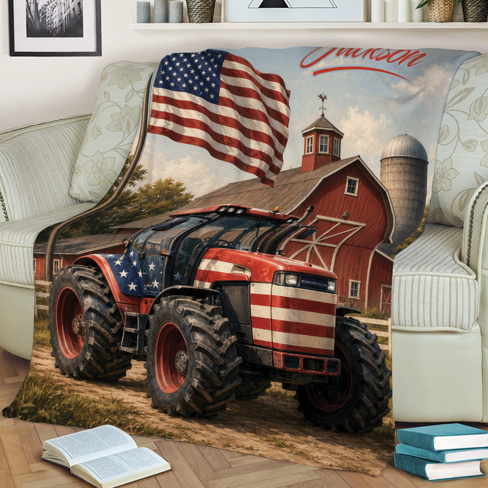 Close view of a patriotic tractor blanket with red barn, silo, American flag, and rustic farm artwork