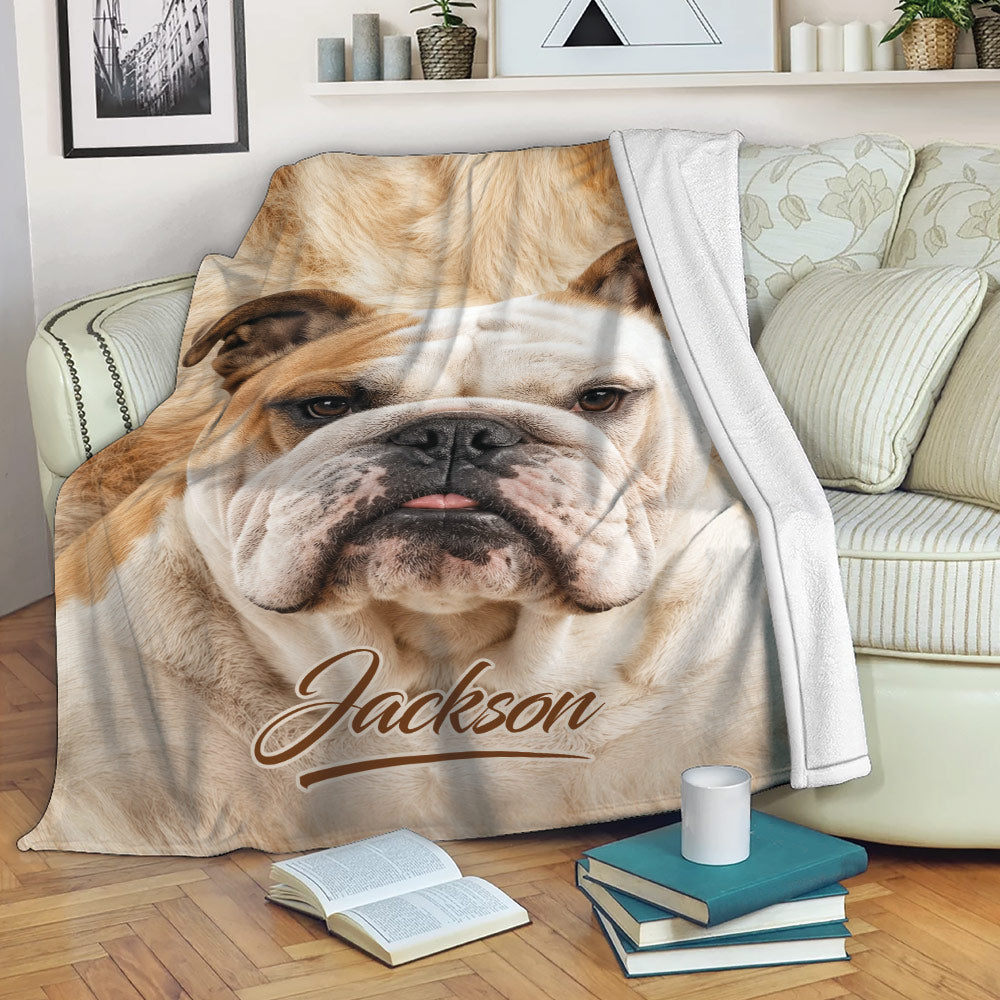 English Bulldog blanket draped over a sofa with a close-up bulldog design in a cozy living room