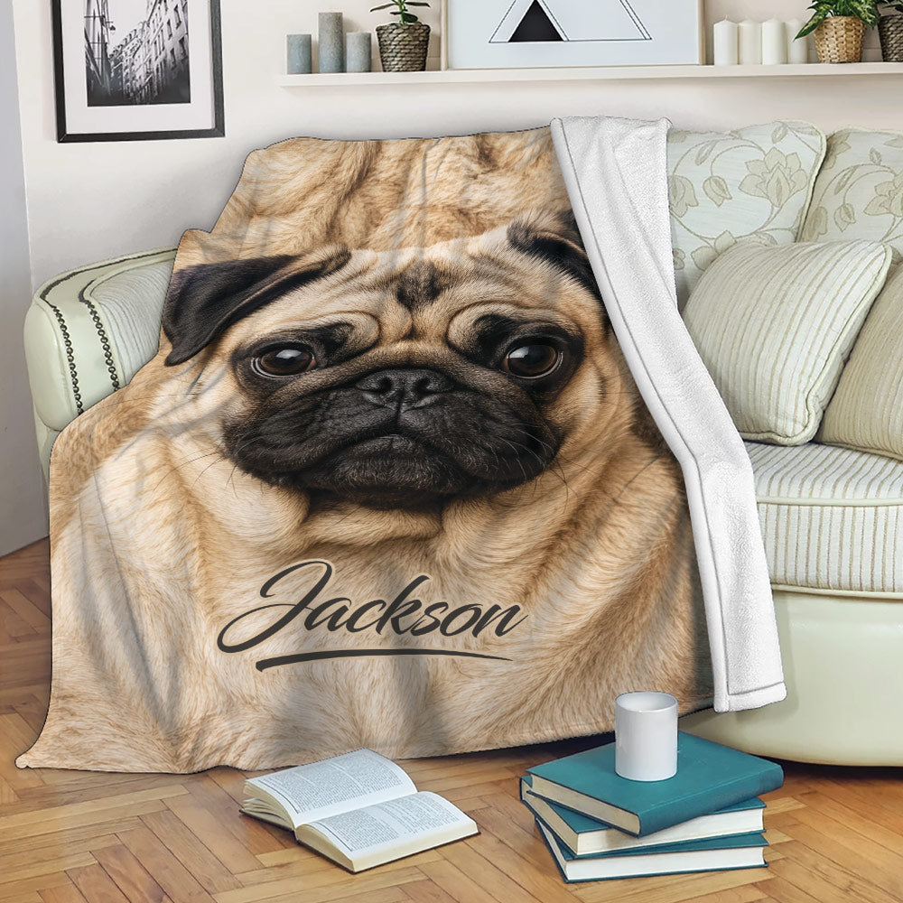 Pug throw blanket displayed on a sofa with a close-up dog design in warm neutral tones