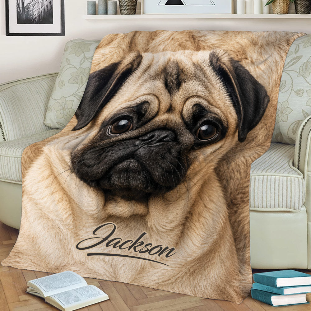 Close-up pug blanket draped across a sofa, featuring expressive eyes and detailed tan fur artwork