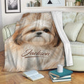 Shih Tzu blanket draped across a living room sofa with cozy dog artwork