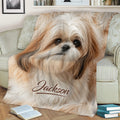 Close view of a Shih Tzu throw blanket styled on a sofa with warm neutral artwork