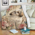 Floral Shih Tzu throw blanket draped over a sofa in a cozy living room