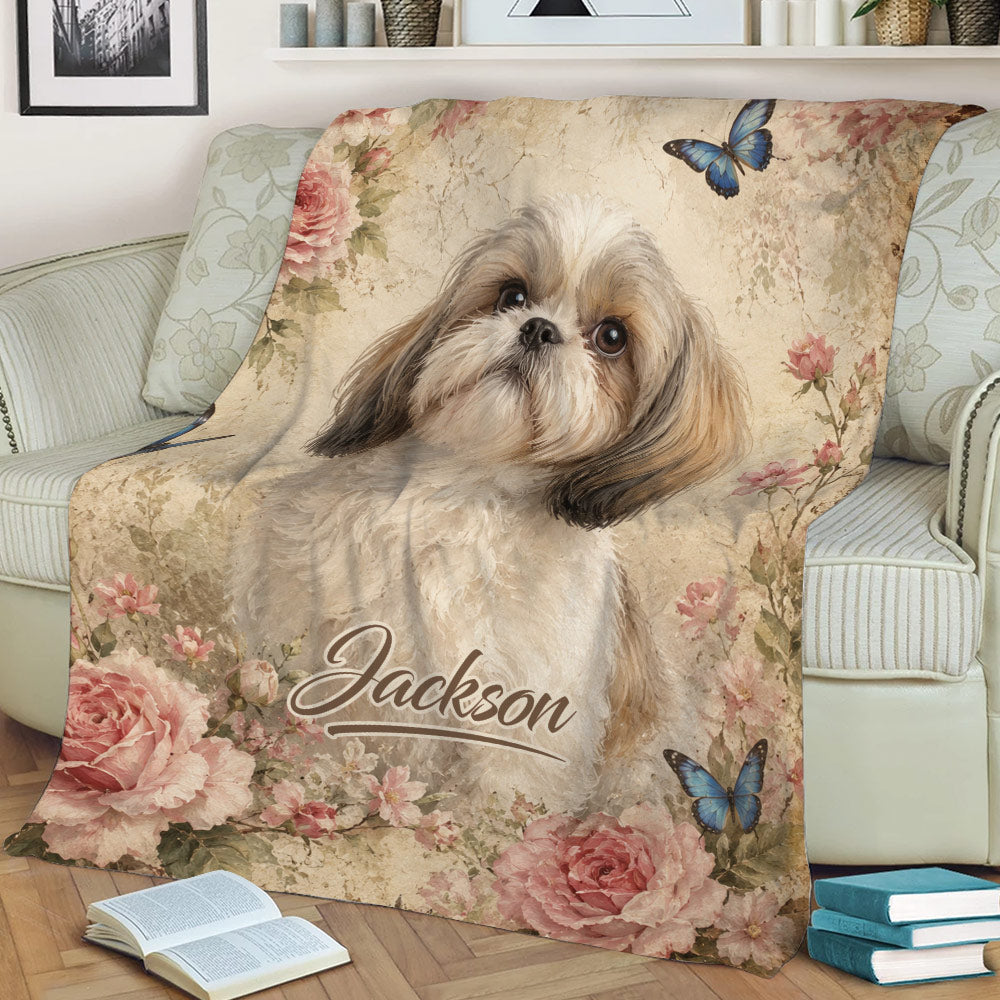 Close view of a Shih Tzu throw blanket with roses, blossoms, and blue butterflies