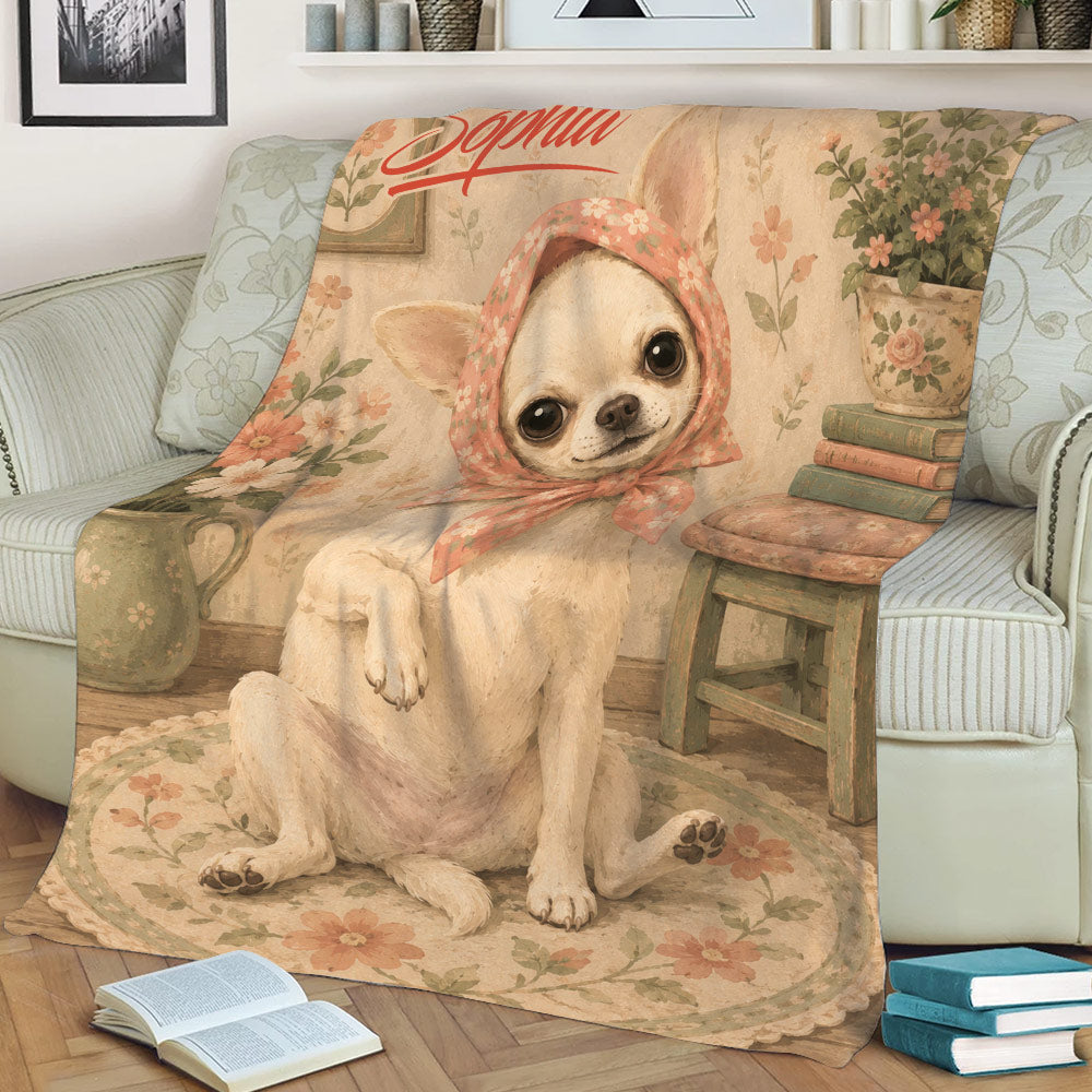Vintage floral Chihuahua blanket spread across a sofa with books and cozy living room decor