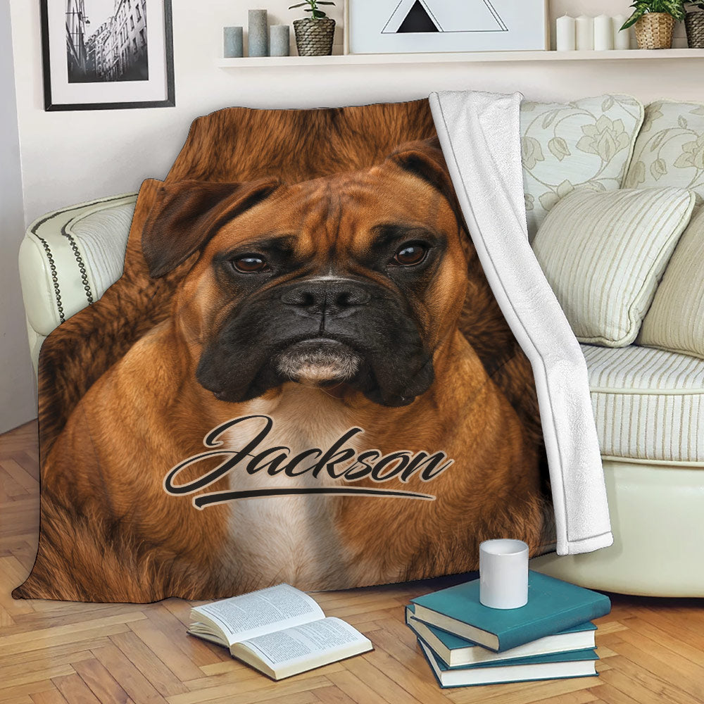Boxer dog blanket draped across a sofa, featuring realistic brown dog artwork in a living room