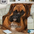 Close view of a Boxer dog throw blanket styled across a sofa with warm brown artwork