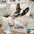 Close lifestyle view of a Boston Terrier throw blanket with sleeping dog artwork on a couch