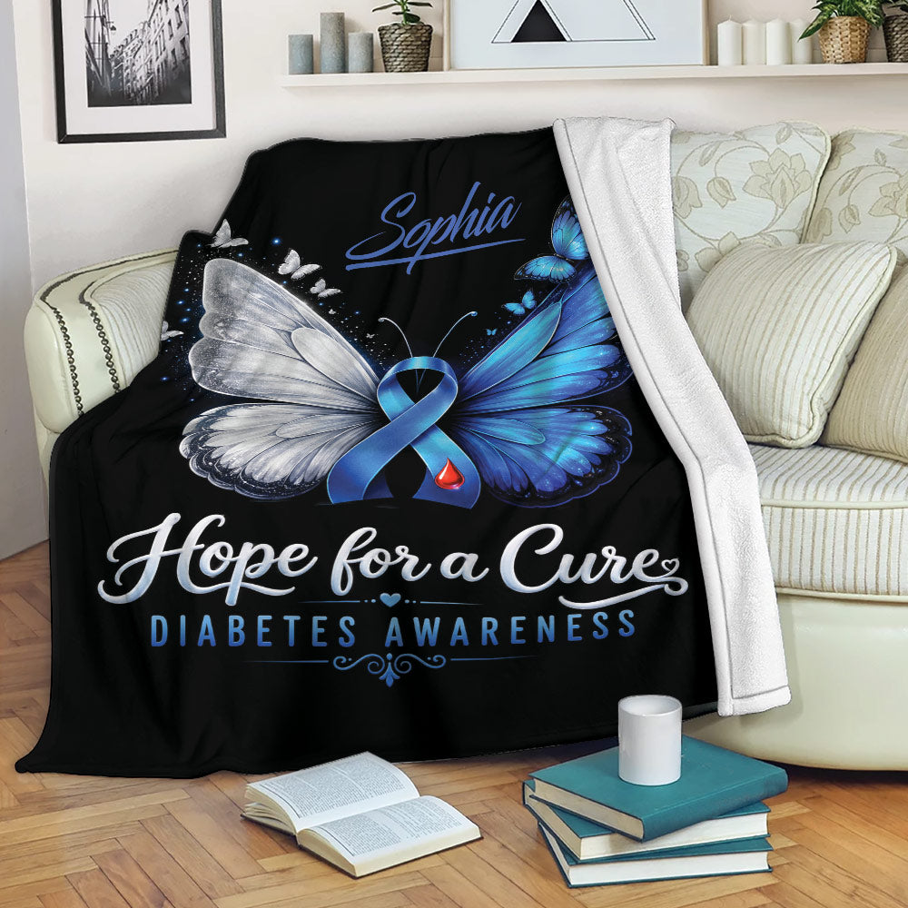 Diabetes awareness throw blanket displayed on a sofa with blue butterfly ribbon artwork