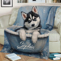 Close view of a blue Husky puppy throw blanket styled across a sofa