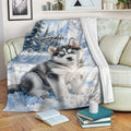 Husky throw blanket draped over a sofa with snowy watercolor dog artwork