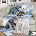 Cozy sofa display featuring a husky puppy blanket with winter mountain artwork