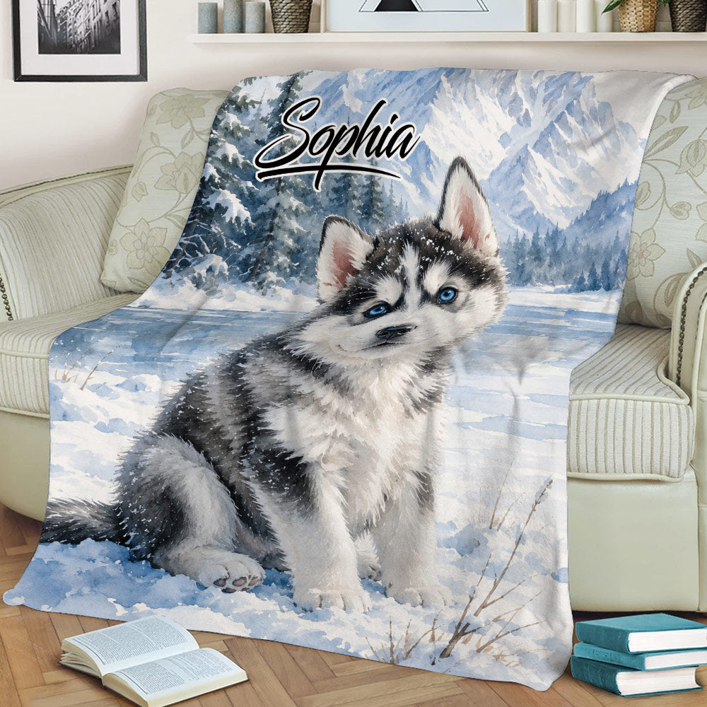Cozy sofa display featuring a husky puppy blanket with winter mountain artwork