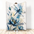 Blue watercolor dragonfly and floral blanket displayed upright with detailed botanical artwork