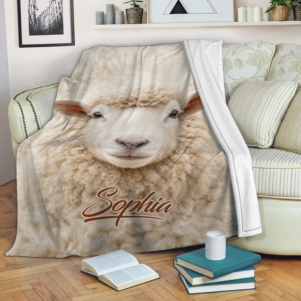 Sheep blanket draped over a sofa with a close-up lamb face and cozy neutral farm theme