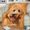 Goldendoodle throw blanket displayed across a sofa with a detailed curly golden dog portrait