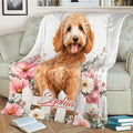 Goldendoodle blanket draped over a sofa with pink flowers and rustic white fence artwork