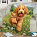 Goldendoodle blanket displayed on a couch with a close-up dog portrait and flower meadow scene